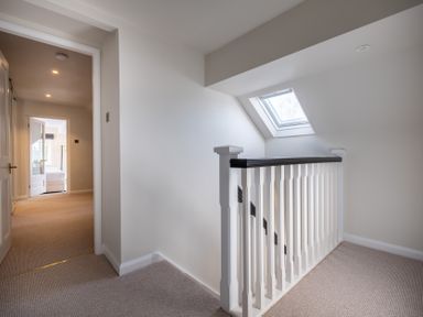 A hallway with a staircase and skylight at Marina View in Bowness-On-Windermere