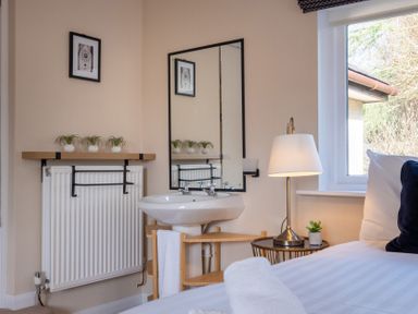 A bedroom with a sink and mirror at Marina View in Bowness-On-Windermere