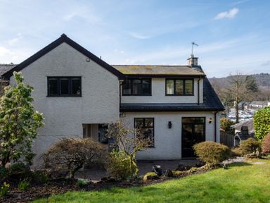 A house with windows and door in the garden at Marina View in Bowness-On-Windermere