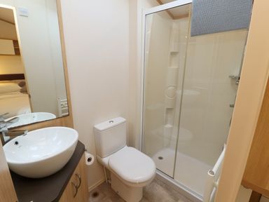 A bathroom with a sink and mirror toilet and shower cabin at Lodge 2 Silverdale