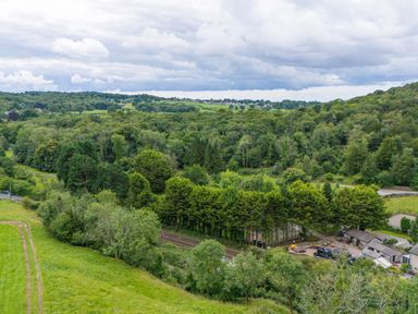 A landscape view of trees and fields at Lodge 2 Silverdale