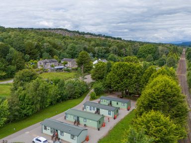 A view of cabins and trees near a railway at Lodge 2 Silverdale