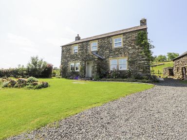 A stone house with garden and gravel path at High Wood Foot in Bampton, Cumbria
