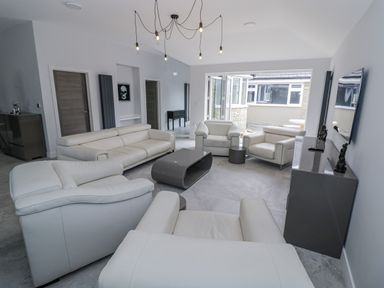 A living room with sofas and a coffee table at Chillon in South Littleton near Honeybourne