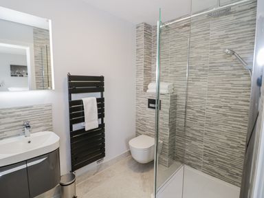 A bathroom with a shower and toilet at Chillon in South Littleton near Honeybourne