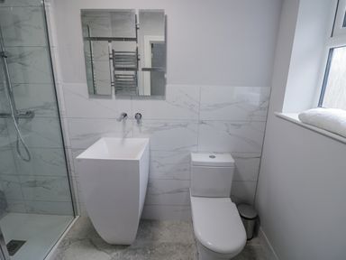 A bathroom with a shower, sink, and toilet at Chillon in South Littleton near Honeybourne
