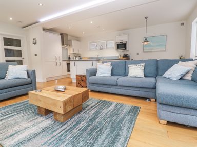 A living room with a sofa and coffee table at The Black Barnacle in Portreath