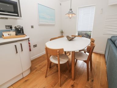 A dining room with a table and chairs at The Black Barnacle in Portreath