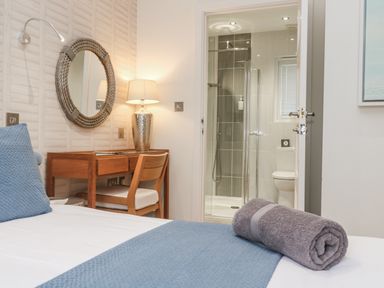 A bedroom with a bed and desk at The Black Barnacle Portreath