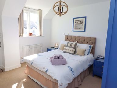 A bedroom with a bed and bedside table at Sea Shore in Seahouses