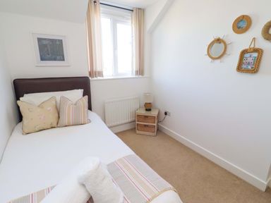 A bedroom with a single bed and nightstand at Sea Shore in Seahouses