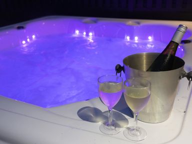A hot tub with champagne and glasses at Dahlia in Portreath