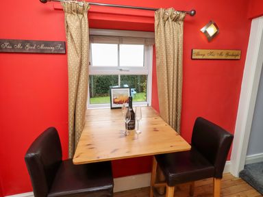 A dining area with a table and chairs at Petty Knowes Cottage in Rochester near Otterburn
