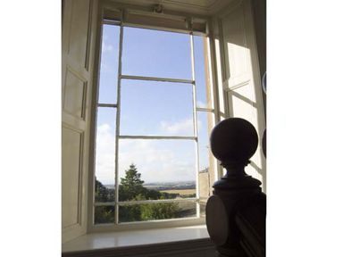 A window with multiple panes showing trees and landscape outside at Bank View in Chirnside