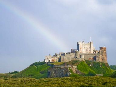 A castle on a hill with a rainbow in the sky at Bank View in Chirnside