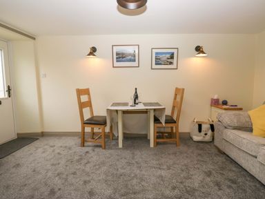 A dining area with a table and chairs at Yeat Stoup Cottage Cockermouth