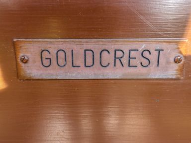 A wooden plaque with the word goldcrest attached to a wooden surface at Goldcrest in Withern near Alford
