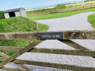 A gate labeled Little Acre leading to a gravel path at Little Acre in Oxenhope