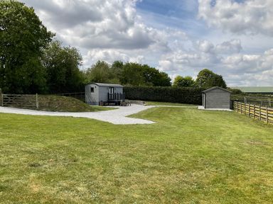 An outdoor space with a mobile home and garden shed at Little Acre in Oxenhope
