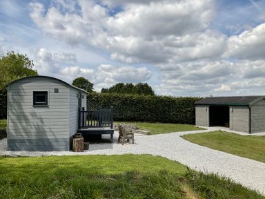 An outdoor area with a shed and deck at Little Acre in Oxenhope