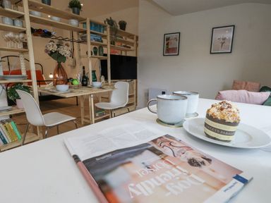 A dining room with a table and chairs at Sea Pink Studio in Swanage