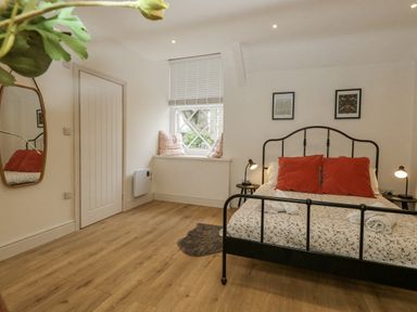 A bedroom with a bed and bedside lamps at Sea Pink Studio in Swanage