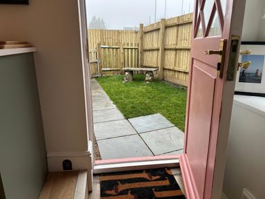 A garden with a stone bench and slate path at Sea Pink Studio in Langton Matravers