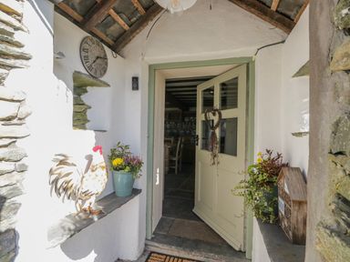An entrance with a door and plants at High Ickenthwaite Farmhouse in Ulverston