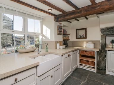 A kitchen with sink and countertops at High Ickenthwaite Farmhouse in Ulverston