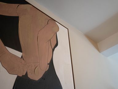 A close up of a framed painting showing the back of a person with hands clasped at Driftwood in Kessingland
