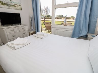 A bedroom with a bed and television at Plimoth N8 Yarmouth