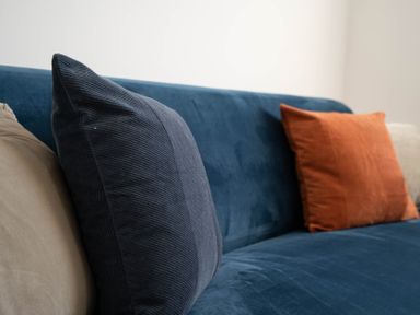 A close up of cushions on a blue sofa at The Cove in Kessingland