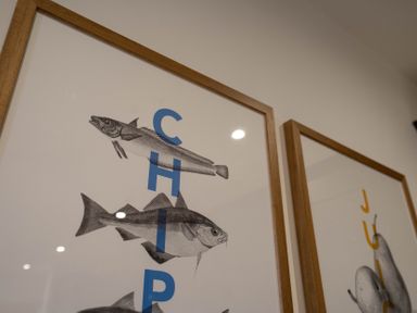 Framed fish illustrations with blue letters forming the word chip in The Cove Kessingland