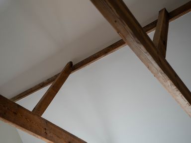 Wooden ceiling beams on a white ceiling at Dunes Cottage in Kessingland