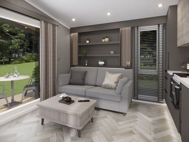 A living room with a grey sofa and wooden coffee table next to a window and bookshelf at Elter Luxury Pod in Keswick
