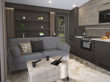 A living area with a grey sofa and cushions a wooden coffee table with mugs and a tablet a kitchen area with dark cabinets an oven and countertop with bread and wine at Elter Luxury Pod in Keswick