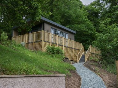 A house with decking and stairs in the outdoor area at Hodge Luxury Pod in Keswick