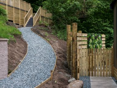 A pathway leading to stairs surrounded by a wooden fence at Hodge Luxury Pod in Keswick
