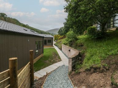 An outdoor area with buildings and a pathway at Dubs Luxury Family Pod in Keswick