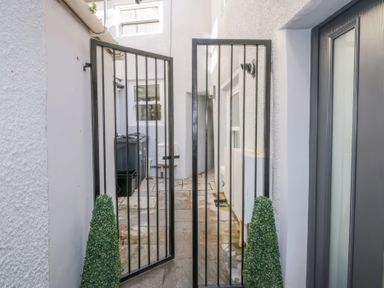 An outdoor area with a gate and planters at Hocking Cottage St Marychurch