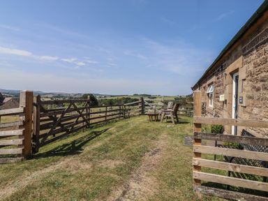 An outdoor area with chairs and a table at Folly View in Eglingham