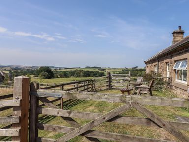 An outdoor area with a fence and chairs at Folly View in Eglingham