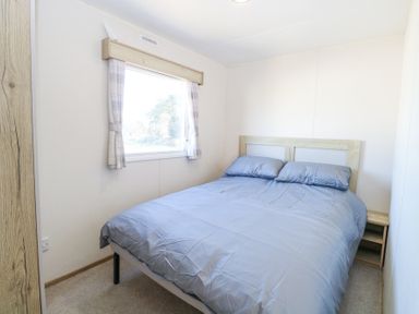 A bedroom with a double bed next to a window at 31A Foxburrow Hang in Fritton near Belton Norfolk