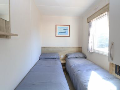 A bedroom with two single beds and a window at 31A Foxburrow Hang in Fritton near Belton Norfolk