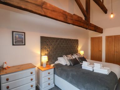 A bedroom with a double bed and folded towels on the bed at Duchess of Hamilton @ Engine Shed in Whitby