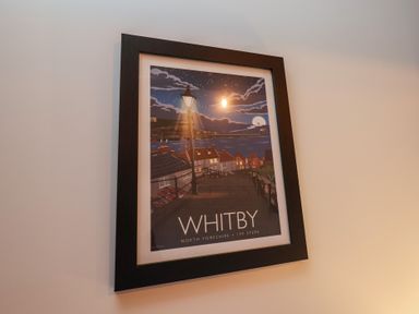 A framed poster of Whitby North Yorkshire 199 steps hanging on a wall at Duchess of Hamilton @ Engine Shed in Whitby