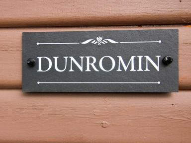 A nameplate displaying DUNROMIN at Dunromin in Montgomery