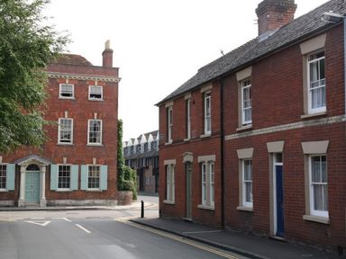 A street with brick buildings and shuttered windows at The Townhouse in Salisbury