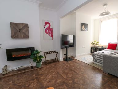 A living room with a couch and a television at Weymouth Seaside House in Weymouth