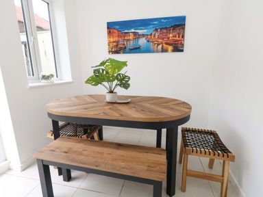 A dining room with a table and chairs at Weymouth Seaside House in Weymouth